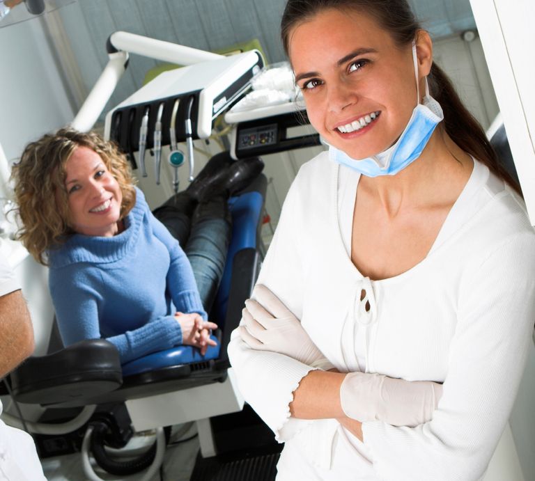 Woman patient smiles as Woman dentist smiles at the camera
