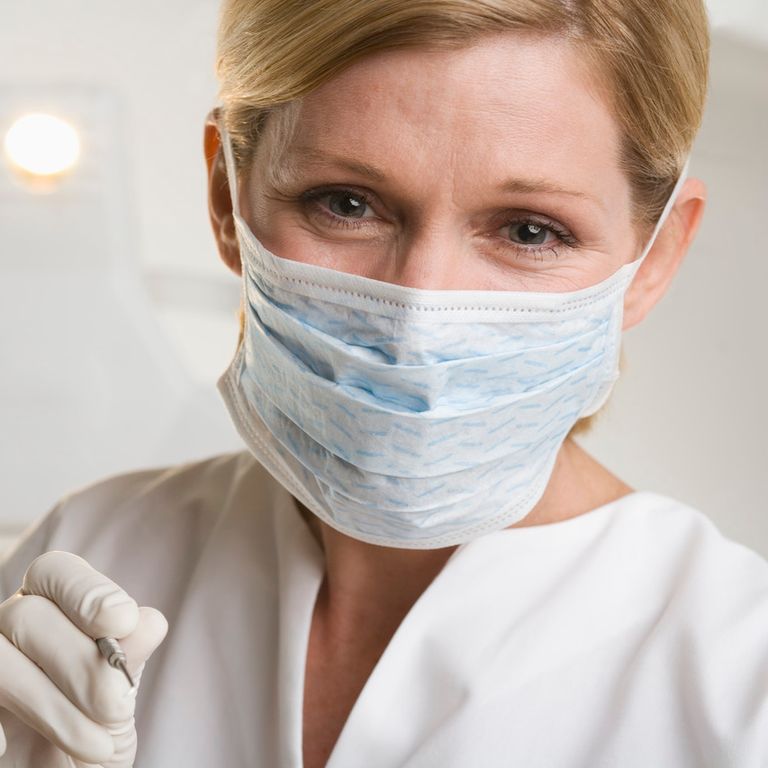 Dental professional woman with mask over face
